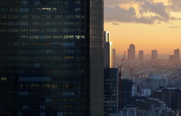 High-rise office buildings are seen during sunset in Tokyo December 10, 2013.