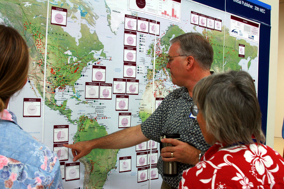 Dan Noble points out oil data to Carolyn Glockhoff and Monty Worthington. Dan Noble points out oil data to Carolyn Glockhoff and Monty Worthington.