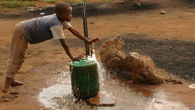 FILE - A child fills a container with water for domestic use in Delmas, east of Johannesburg, South Africa. FILE - A child fills a container with water for domestic use in Delmas, east of Johannesburg, South Africa.