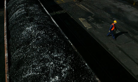 A worker walks past freshly-mined, high quality coal awaiting transport on a train at the Wieczorek coal mine April 14, 2004 in Katowice, Poland. Photograph: Sean Gallup/Getty Images A worker walks past freshly-mined, high quality coal awaiting transport on a tra