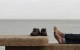 A resident enjoys the weather on an unseasonably hot day at the waterfront in Montevideo, Uruguay, Aug. 23, 2012. The temperature reached almost 30 degrees Celsius, while the typical average temperature in August is around 10 degrees Celsius. REUTERS/Andres Stapff