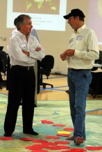 Jim Cathcart and Jon Warren Lentz discuss population issues represented by colored dots. Jim Cathcart and Jon Warren Lentz discuss population issues represented by color